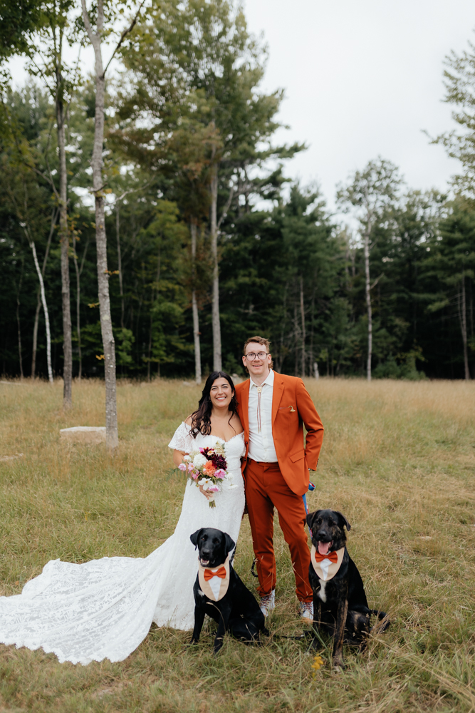 Bride and groom poses with their dogs on their wedding day