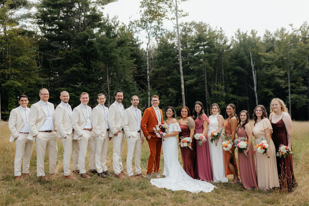 Wedding bridal party pose in a field at the Barn at Pinestone near Lake Placid