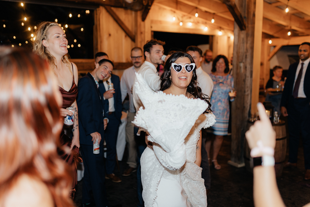bride on the dance floor in heart shaped sunglasses at the Barn at Pinestone