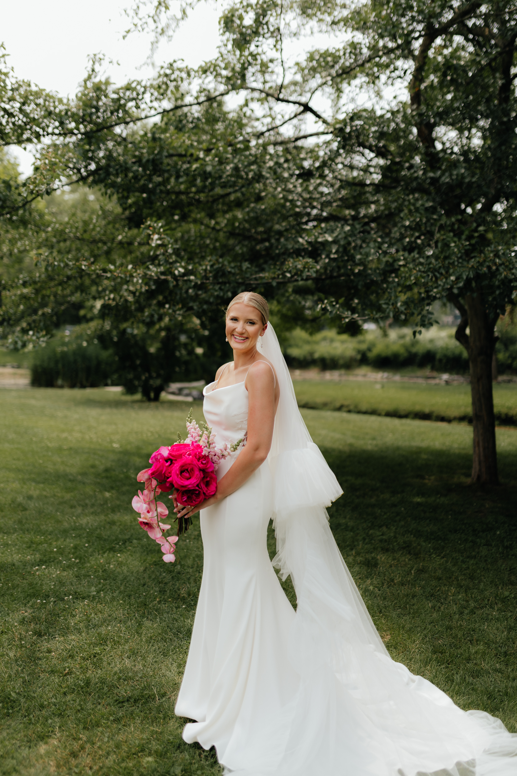 Portrait of an elegant bride and a pink bouquet on her wedding day