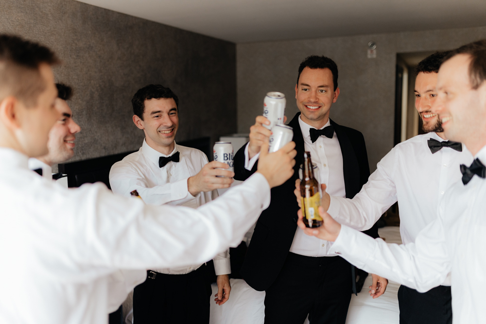 Groom and groomsmen cheers on his wedding day