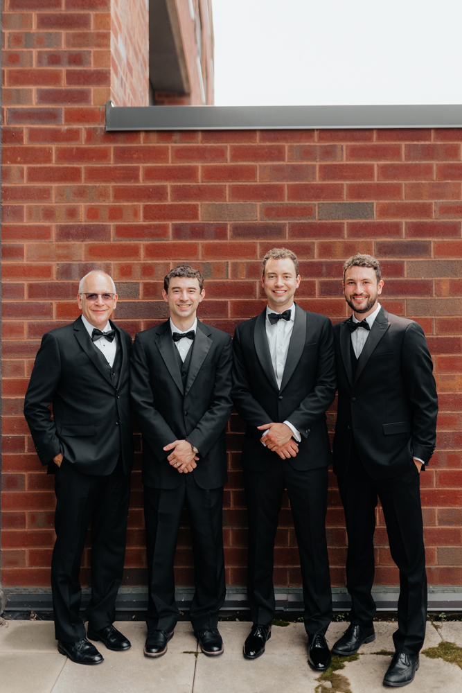 Groom and his guys on his wedding day in black suits
