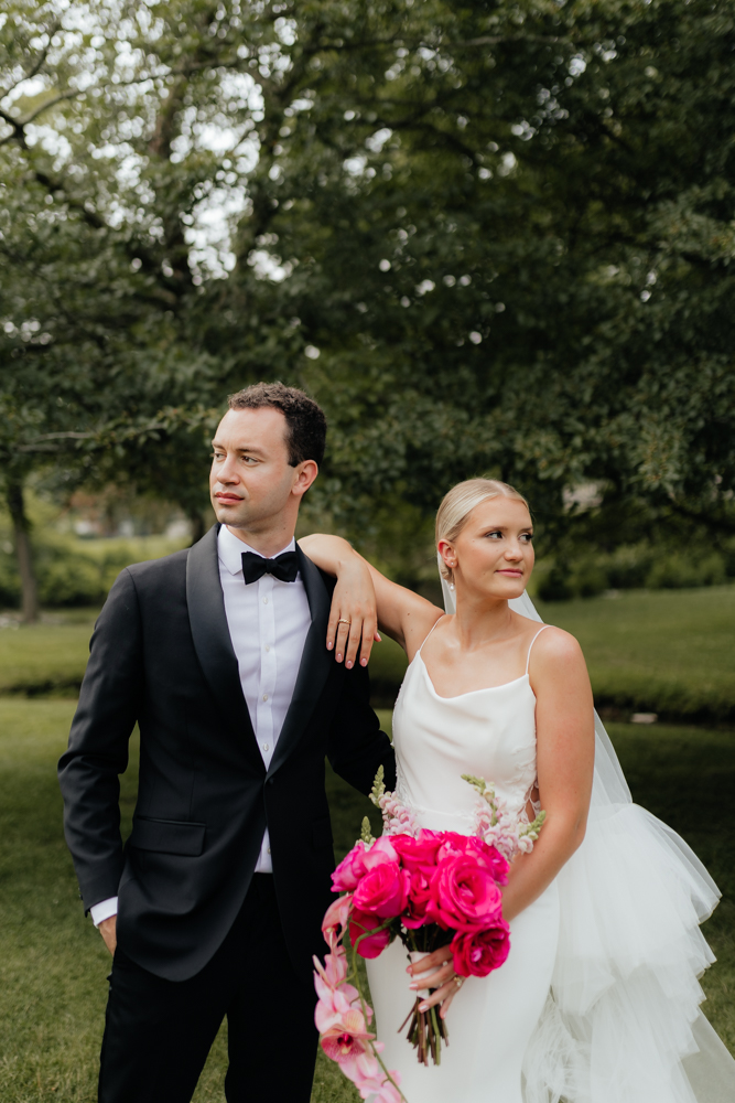 Elegant bride and groom on their wedding day with hot pink bouquet