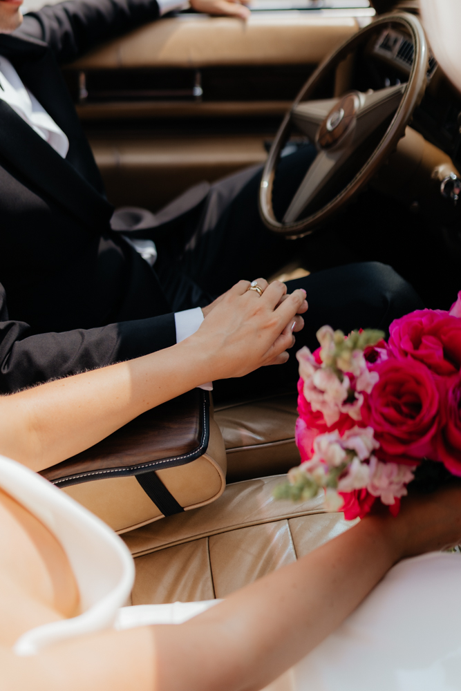  Classy bride and groom on their wedding day with a tan vintage car
