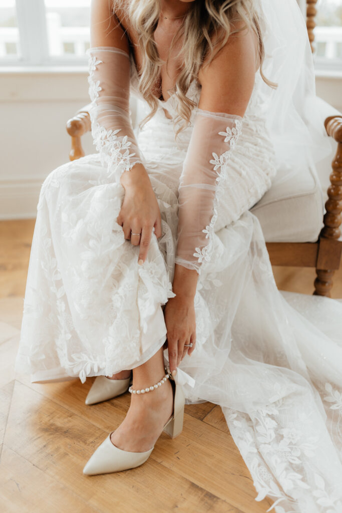 Bride putting on her shoes on her wedding day