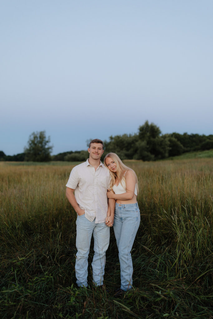 Couple in a field at sunrise