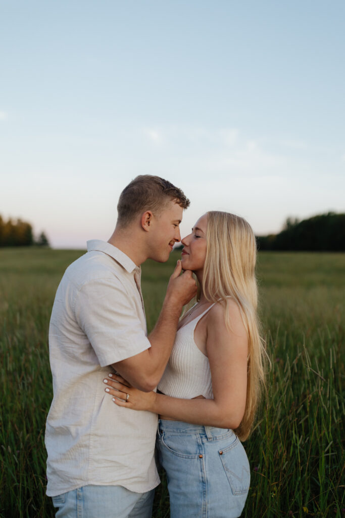 Couple in a field at sunrise