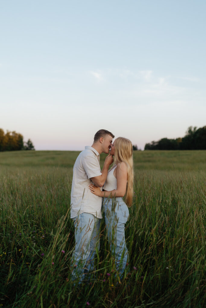 Couple in a field at sunrise