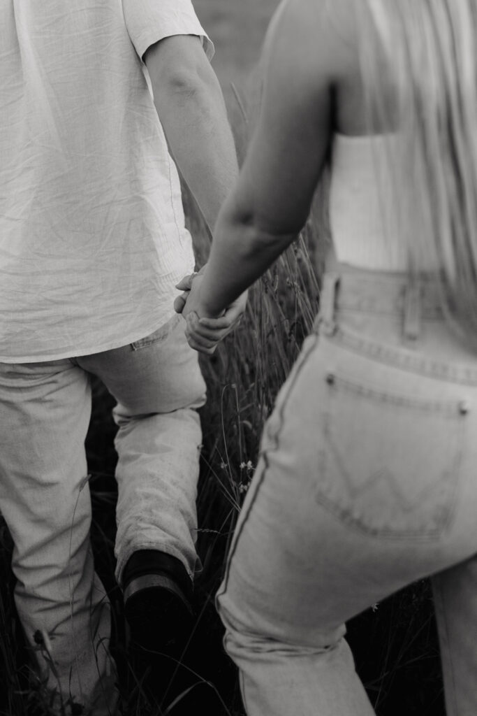 Couple in a field at sunrise walking