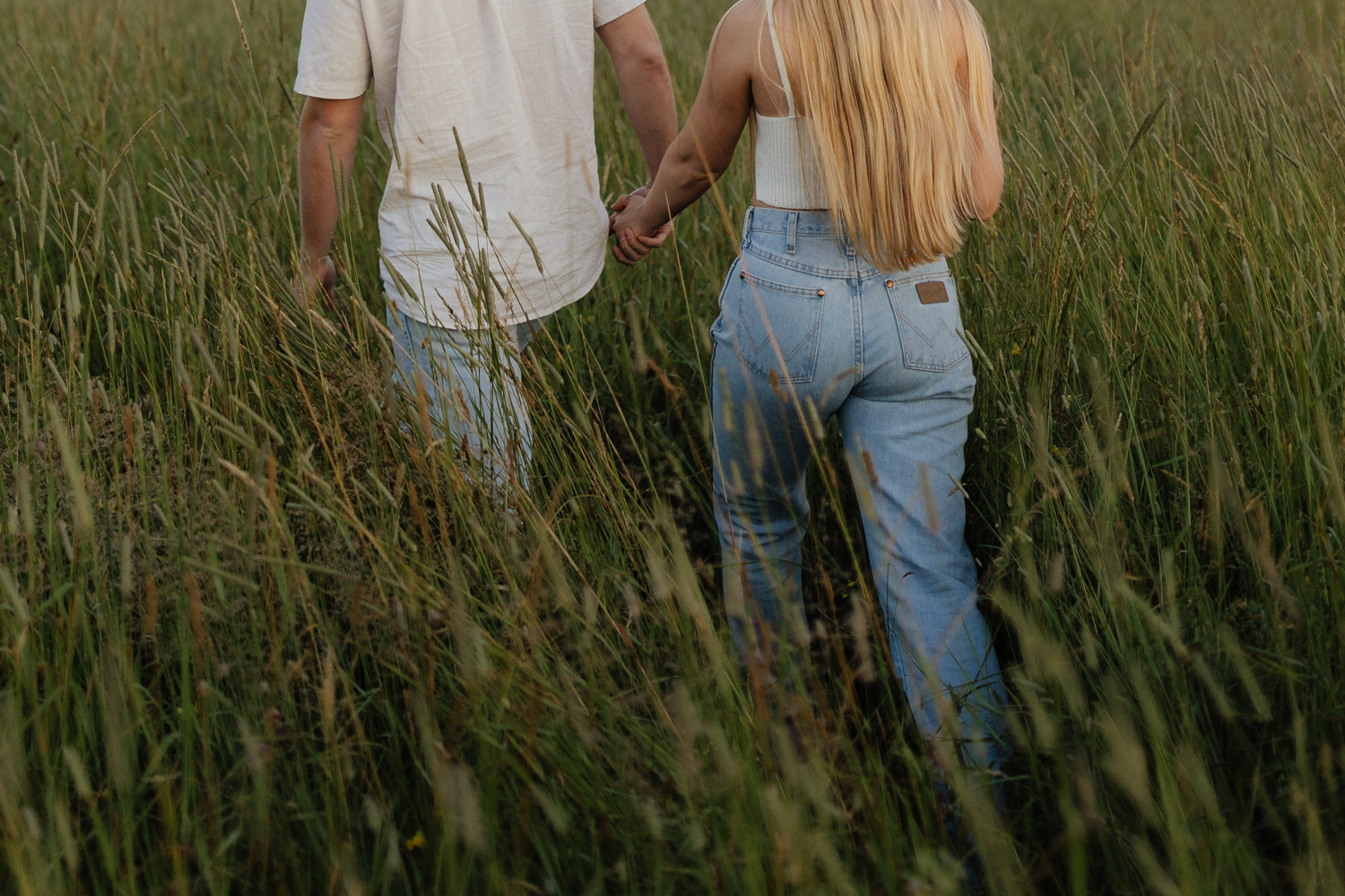 Couple in a field at sunrise walking