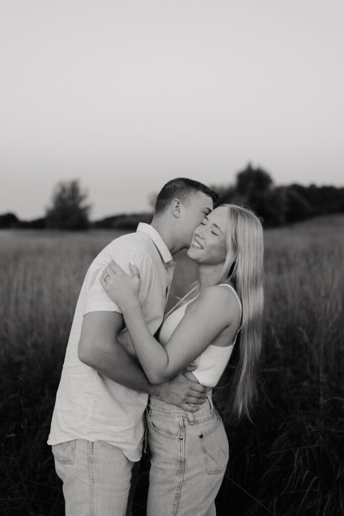 Couple in a field at sunrise