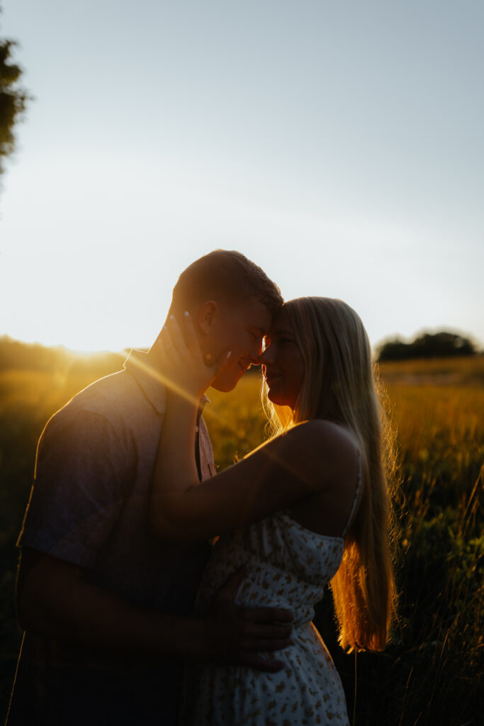 Couple in a field at sunrise