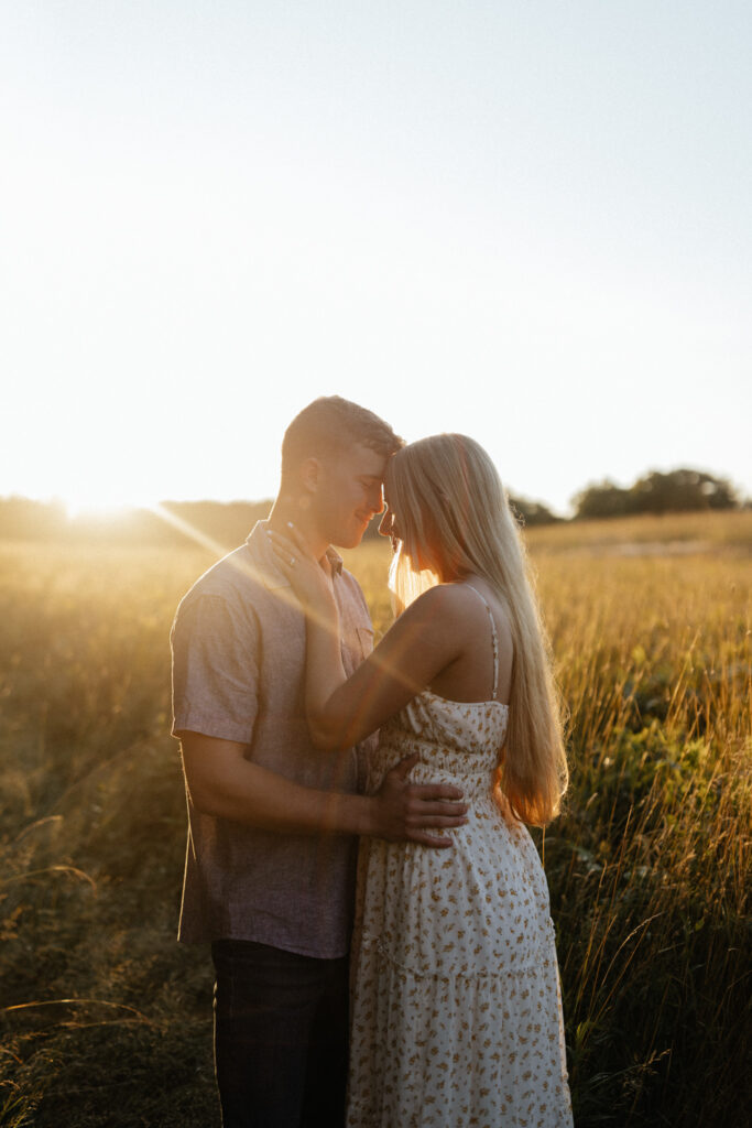 Couple in a field at sunrise