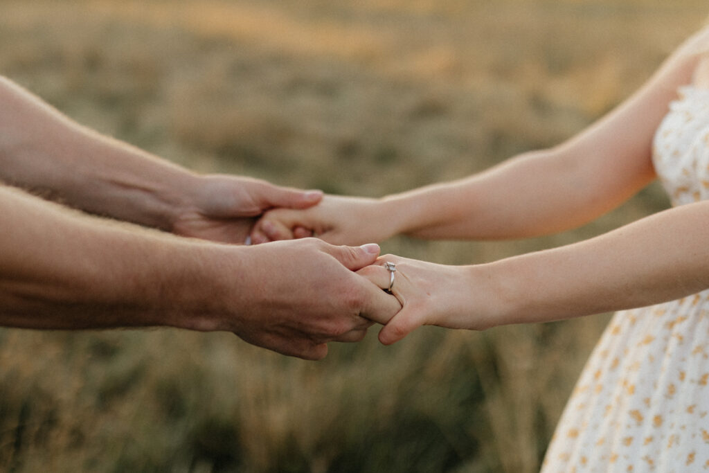 Couple in a field at sunrise dancing