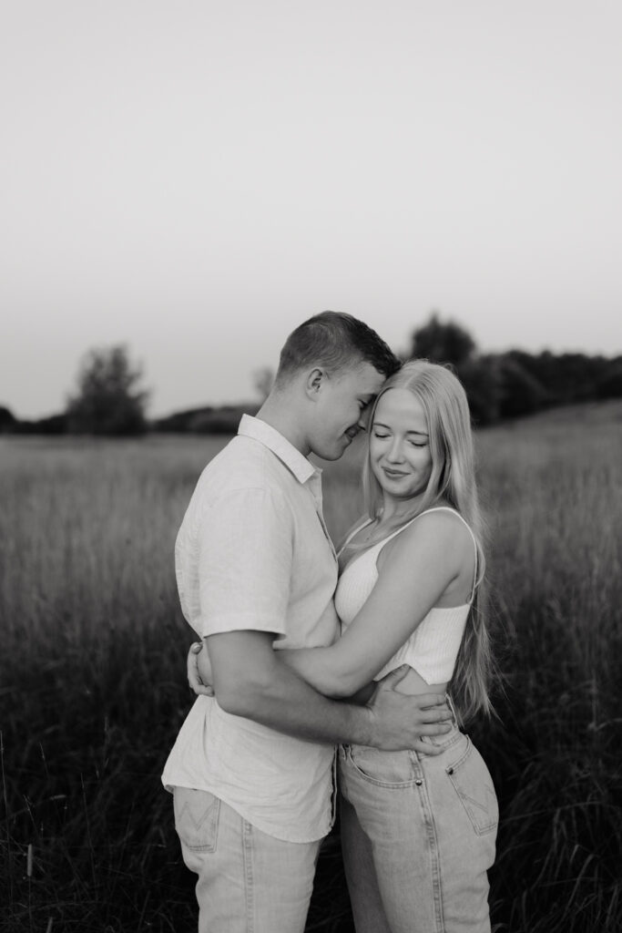 Couple in a field at sunrise