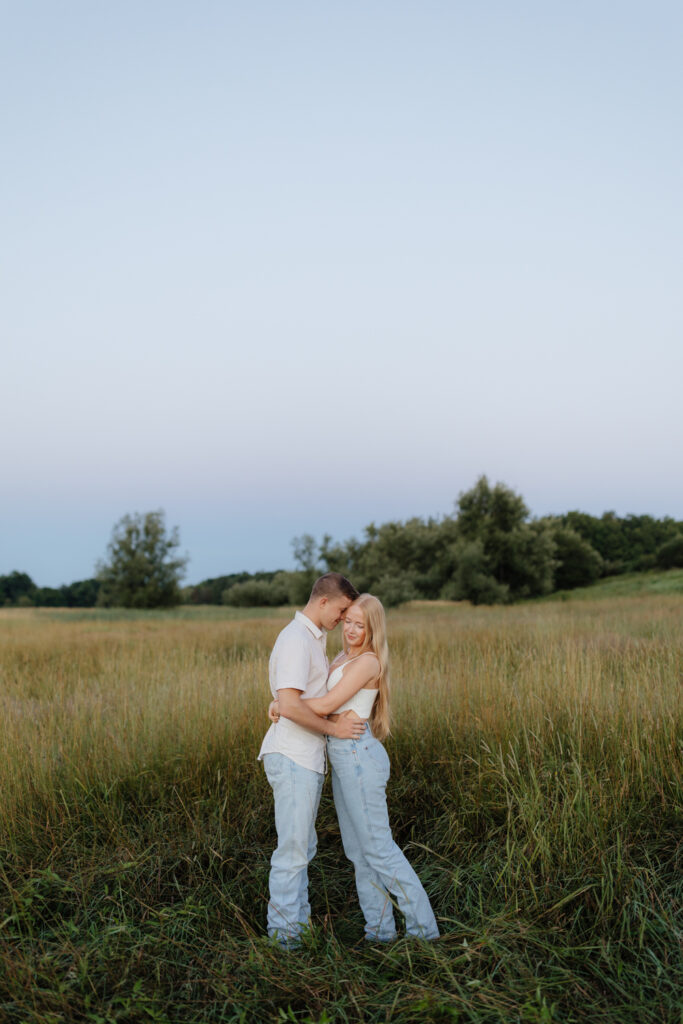 Couple in a field at sunrise