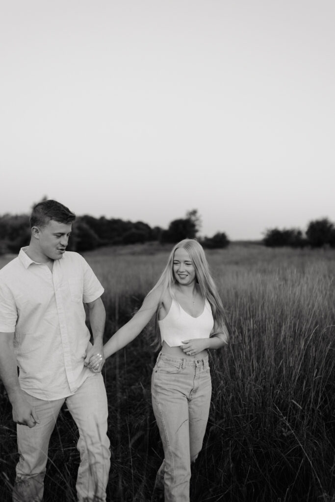 Couple in a field at sunrise walking