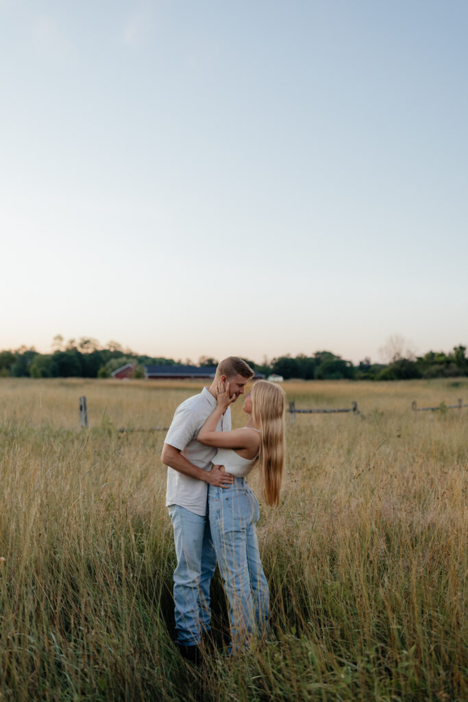 Couple in a field at sunrise