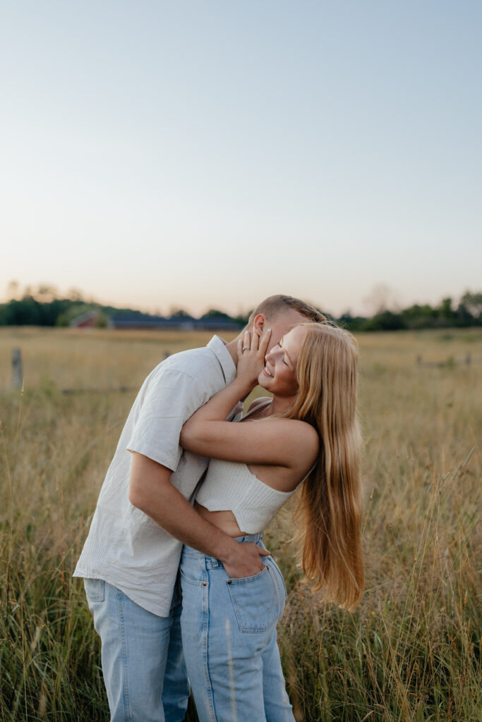 Couple in a field at sunrise