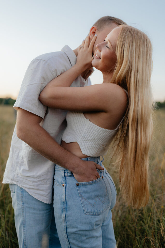 Couple in a field at sunrise