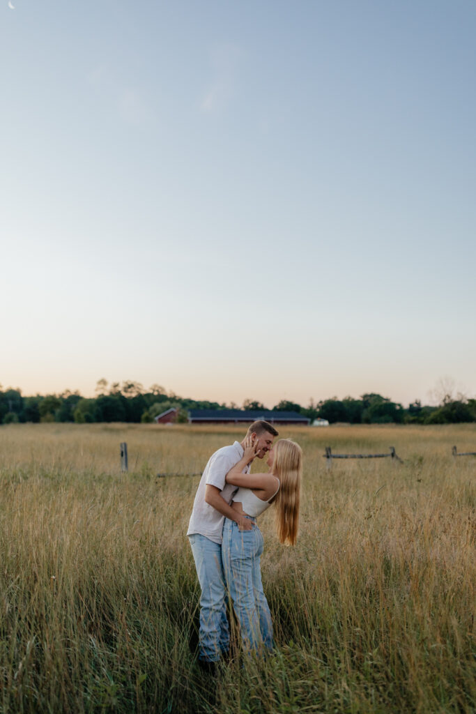 Couple in a field at sunrise