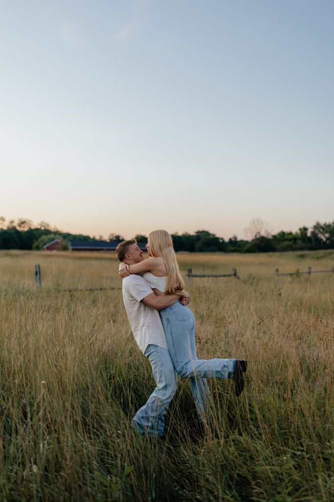 Couple in a field at sunrise