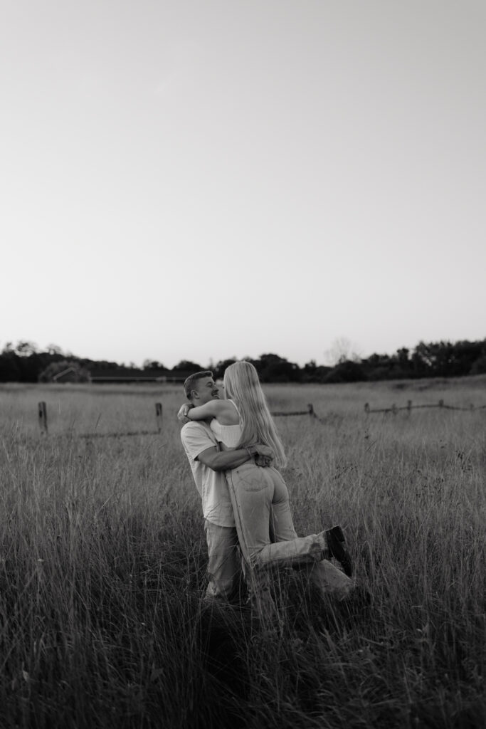 Couple in a field at sunrise