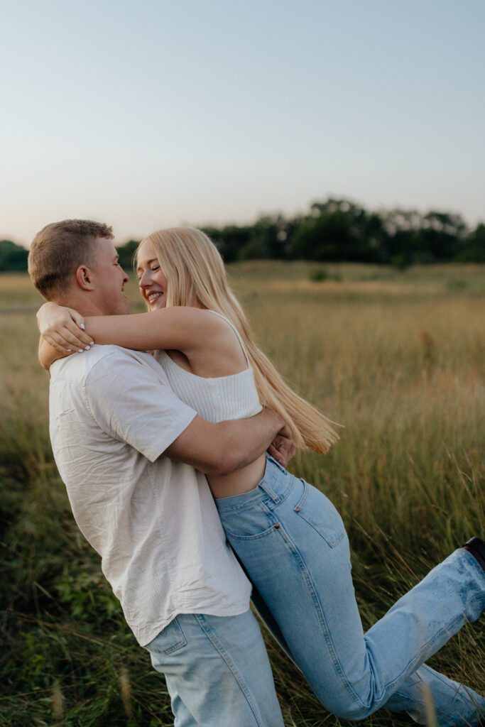 Couple in a field at sunrise