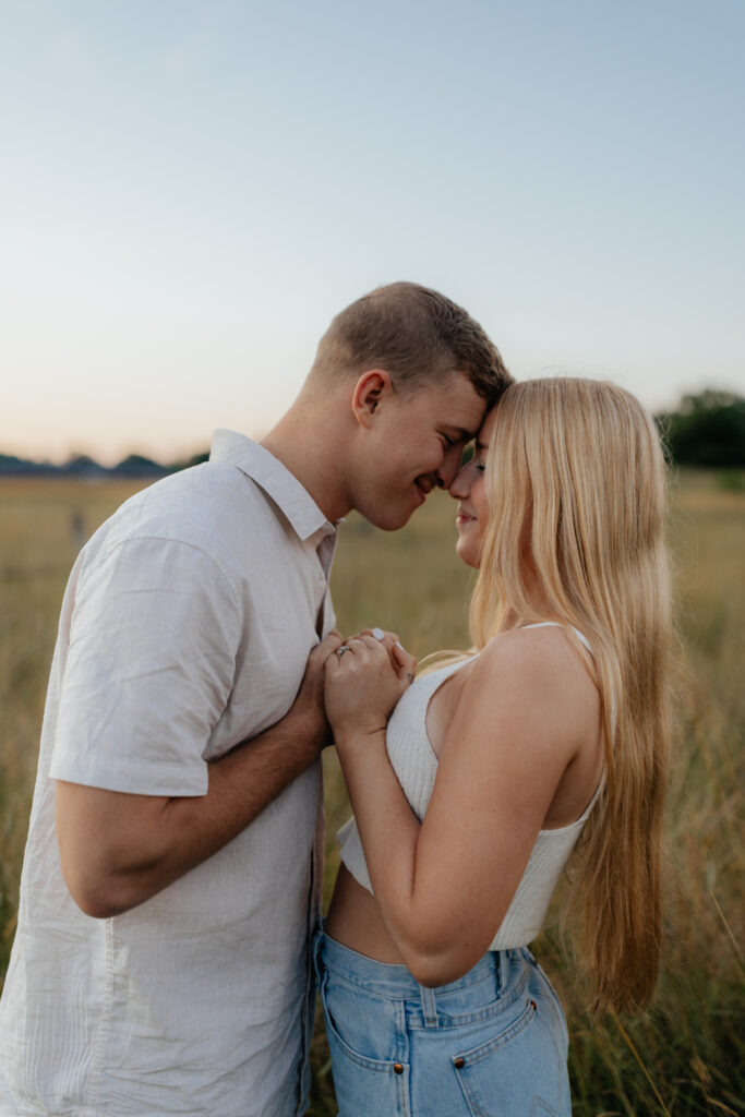 Couple in a field at sunrise