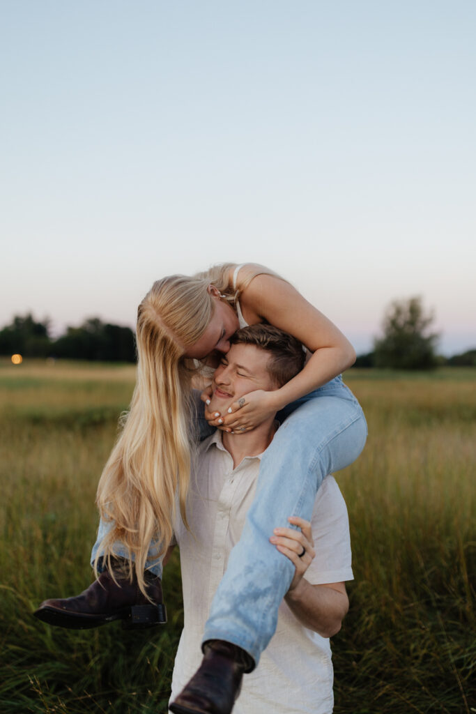 Couple in a field at sunrise