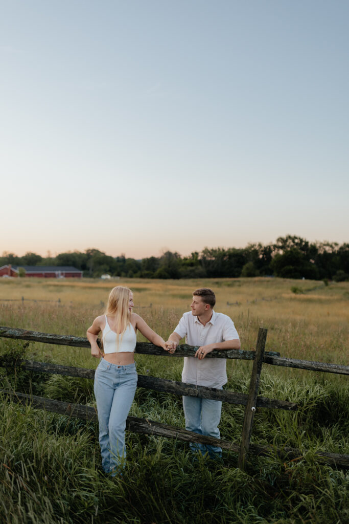 Couple in a field at sunrise near a barn