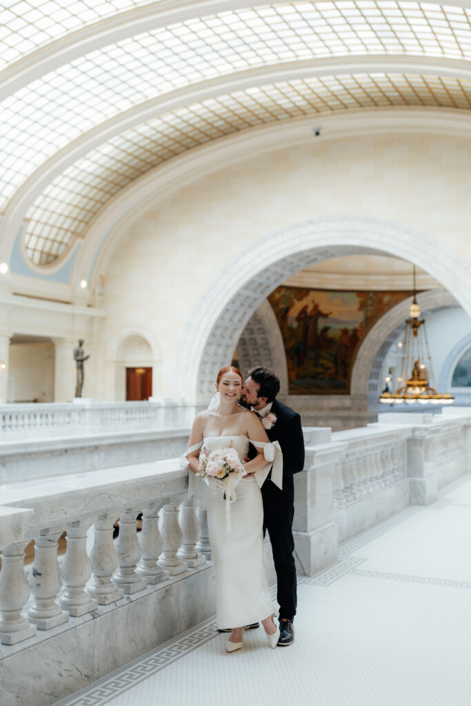 Couple eloping in salt lake city on balcony