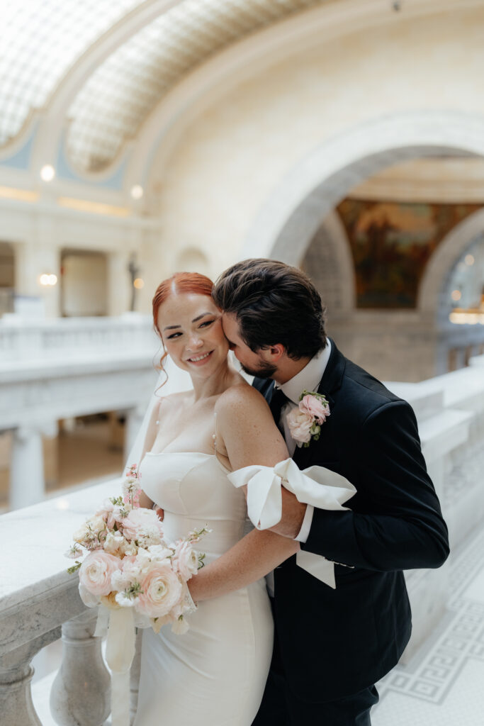 Couple eloping in salt lake city on balcony