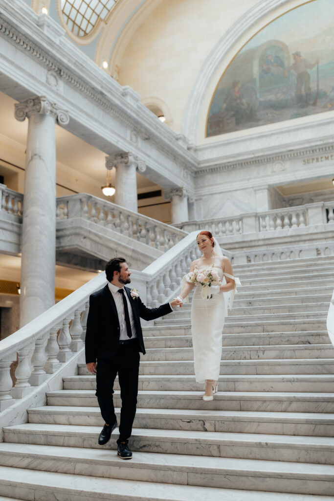 Couple eloping in salt lake city walking down steps