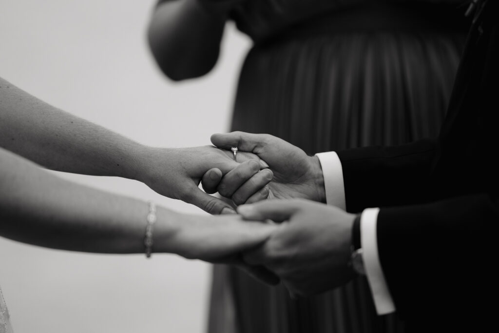 detail of hands at lakeside ceremony in the Adirondacks