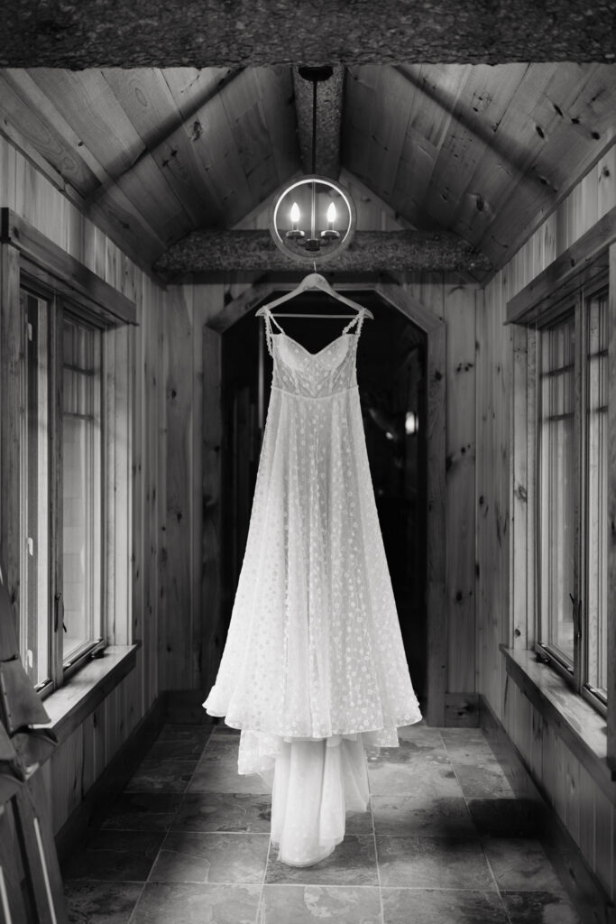 wedding dress hanging in lodge