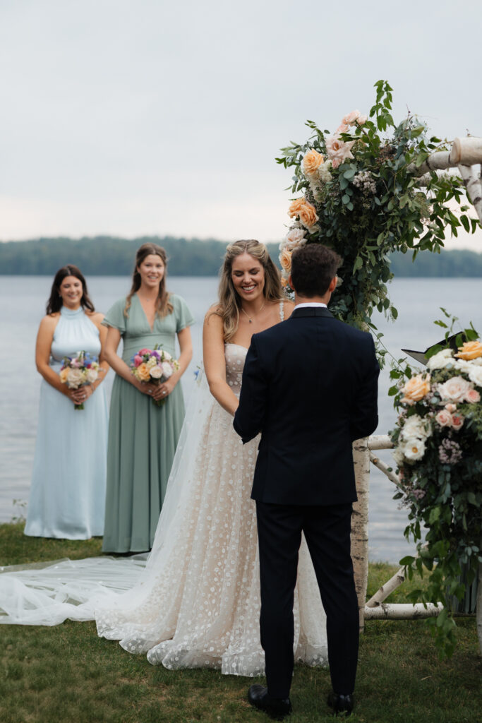 bride laughs at lakeside ceremony in the Adirondacks