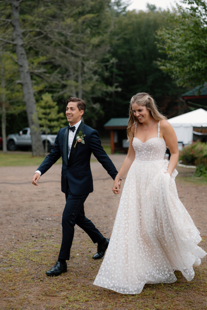 bride and groom enter tented reception