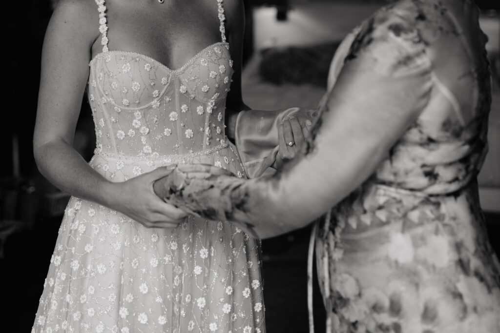 bride and her mom share a moment