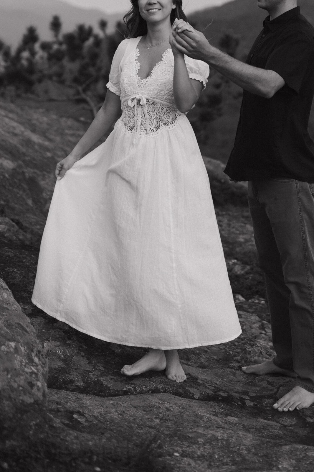 Engaged couple dance on top of a mountain in the ADK