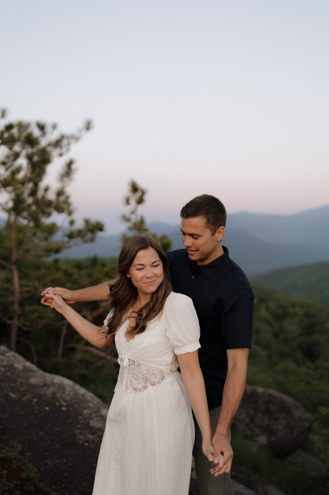 Engaged couple dance on top of a mountain in the ADK