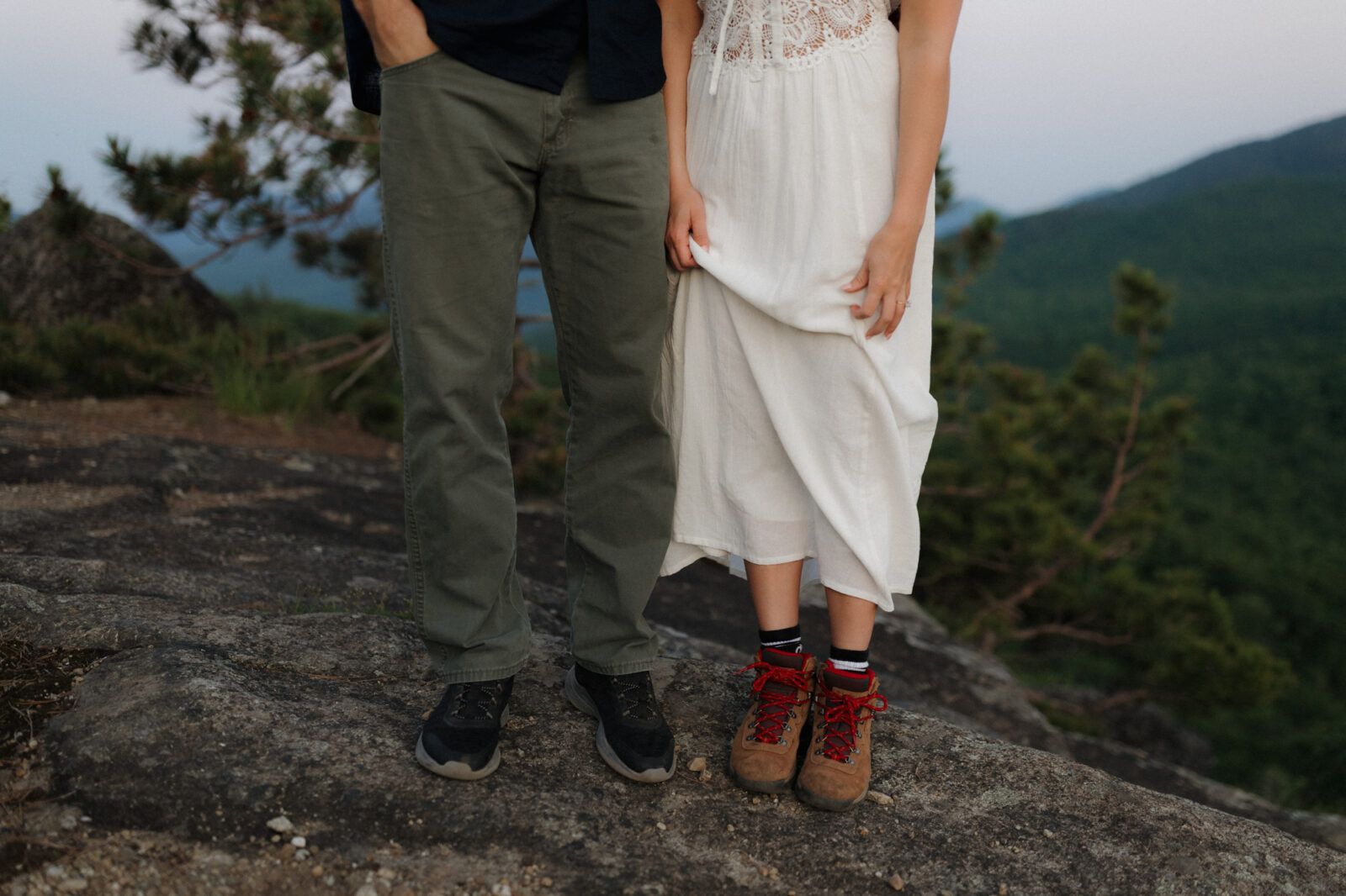 Engaged couple show off their hiking books