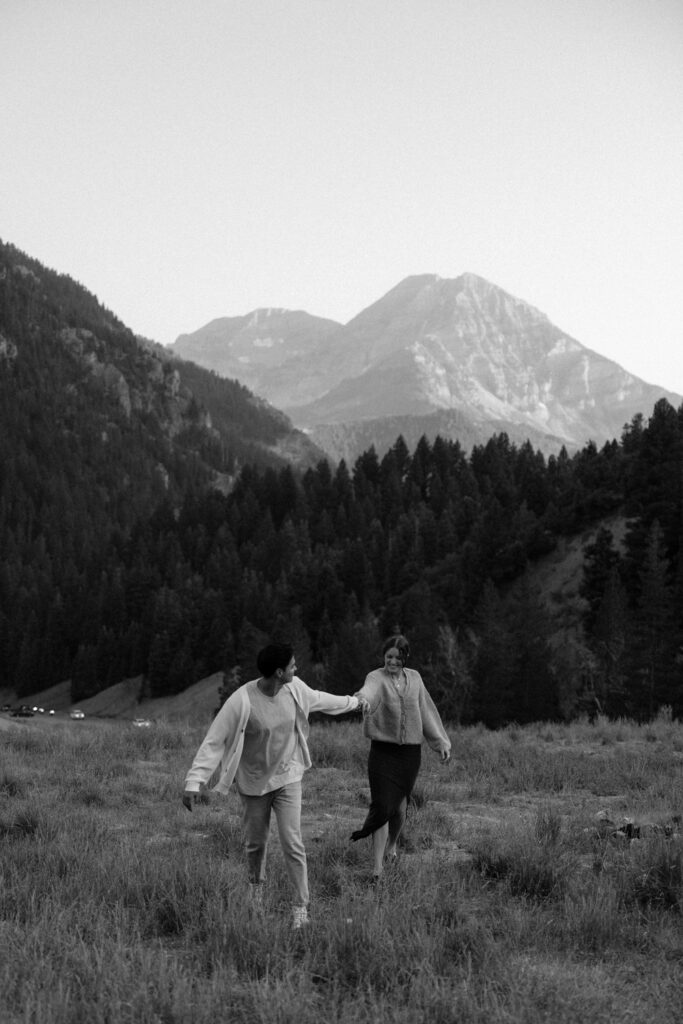 Couple running around at TIbble Fork Reservoir in Utah Mountains