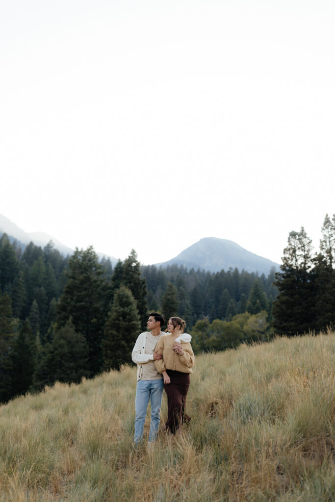 Couple stands at TIbble Fork Reservoir in Utah